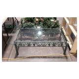 Glass top coffee table with greenish color metal