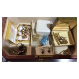 Jewelry box with some jewelry, cuff links, pins