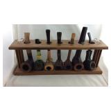 Seven tobacco pipes and stand
