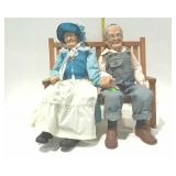 Maw and Paw dolls on wooden rocking bench seat