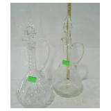 Two tall glass pitcher type cruet one etched
