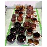 Collection of pottery kitchen wares, creamers and