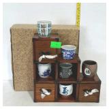 Tea cups and display shelf with drawers, stands