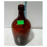 Brown glass wine bottle marked I. W. Harper