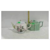 Two teapots. One in pale green and one