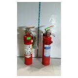 Two small fire extinguishers with wall mount