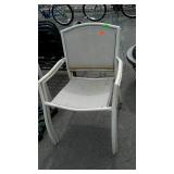 Two lawn chairs show use and weather wear