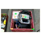 Plastic milk crate with jig saw, knee pads, water