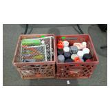 Two plastic milk crates with spray paints and