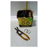 Box of new retaining clips and used tool for