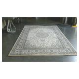 Beige toned area rug. Match to lot 800. 63" ×