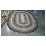Braided room rug measures a 103 inches long, by