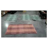 Group of four outdoor rugs, the three larger