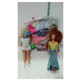 Two Barbie style dolls with bag of clothing