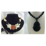 Two black beaded necklaces:  Black carved stone