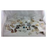 23 match pairs of earrings plus single earrings