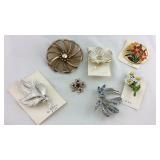 One Nancy Pell brooch and six floral style