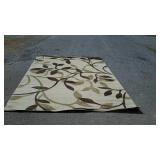 Tan area wool rug with flower design, measures