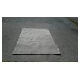 Grey area rug, does need to be cleaned measures