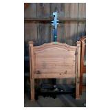 Twin bed. Wooden headboard and metal rails. Paint