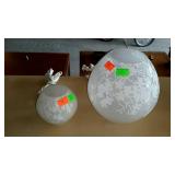 Two glass globe lamps with floral motif. One is