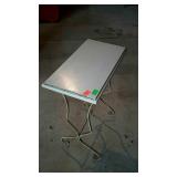 Small wrought iron stand with wooden top. Has a