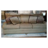 Overstuffed sofa in dark neutral tone with four