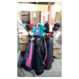 Three golf bags with assorted clubs