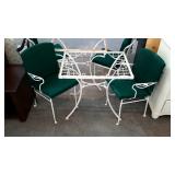 Wrought iron patio cafe table and two chairs.