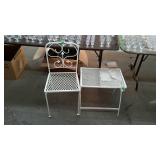 Single wrought iron patio chair and side table.