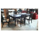 Black dinning table, with six chairs, does have