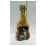 Guitar shaped plastic bottle of popcorn having