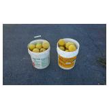 Two buckets of softballs
