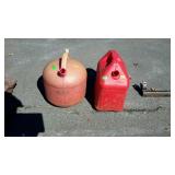 Two fuel cans, missing the tops to them