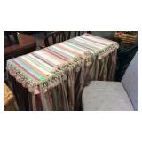 All purpose table with fringed striped cloth cover