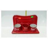 Red enameled wall rack with three cups marked Zeep