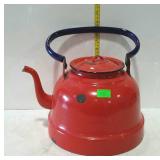 Red enameled tea kettle with blue handle