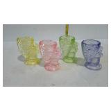 Set of four colored glass egg cups with bunny