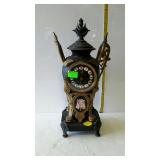 Ornate key wind clock with Eqyptian face design -