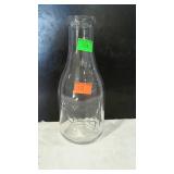 Quart dairy bottle with embossed cow design. also