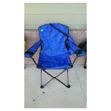 Blue folding camping chair with bag, located on