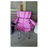 Pink folding camping chair with bag, located on