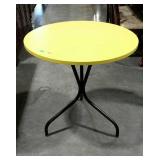 Sunroom table with yellow top and tri-footed