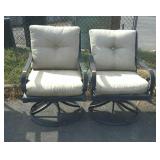 Two patio swivel chairs with Sunbrella cushions.
