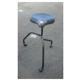 Three wheeled work stool with bicycle style seat.