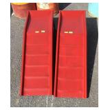 Pair of red painted metal car ramps