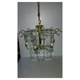 Ceiling light fixture with a brass tone frame