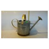 Galvanized watering can with gold finish handles