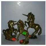 Three brass unicorn figures