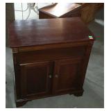 Entertainment cabinet with open secondary shelf